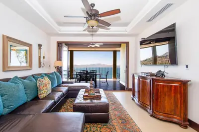 a living room with a couch and a ceiling fan at 360 Splendor 308F-Ocean View Residence-Breakfast in Playa Flamingo