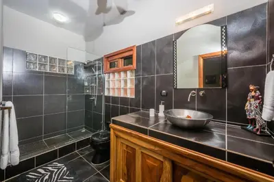 a bathroom with a sink and a mirror at Casa Suenos-Beautiful Beachfront House in Tempate