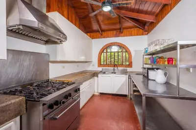 a large kitchen with a stove and a sink at Casa De La Playa- Beachfront Home At Flamingo in Playa Flamingo