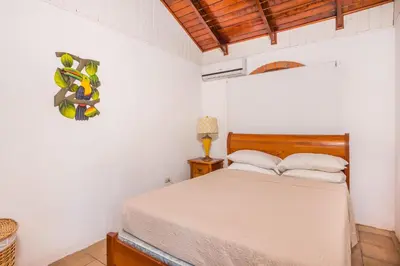 a bedroom with a bed in a white room at Casa De La Playa- Beachfront Home At Flamingo in Playa Flamingo