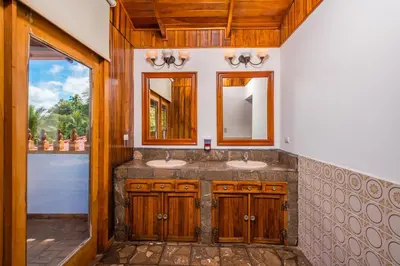 a bathroom with two sinks and a window at Casa De La Playa- Beachfront Home At Flamingo in Playa Flamingo