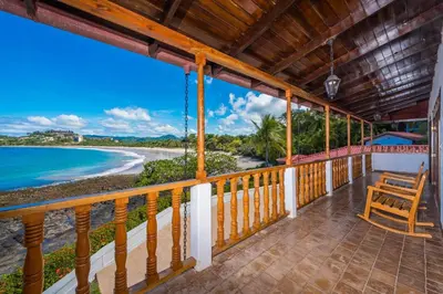 a balcony with a view of the beach at Casa De La Playa- Beachfront Home At Flamingo in Playa Flamingo