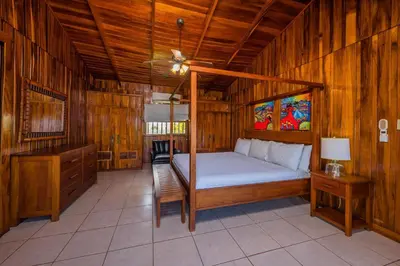 a bedroom with a bed and a ceiling fan at Casa De La Playa- Beachfront Home At Flamingo in Playa Flamingo
