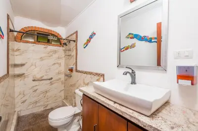 a bathroom with a sink and a toilet and a shower at Casa De La Playa- Beachfront Home At Flamingo in Playa Flamingo