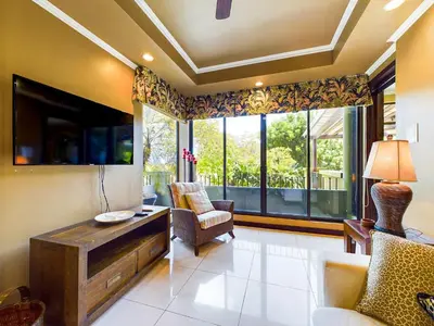 a living room with chairs and a large window at Villa Carao #3 - A Private 4 Bedroom Resort Villa in Brasilito