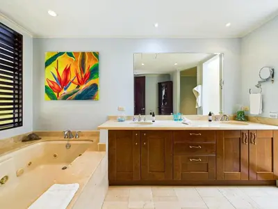 a bathroom with two sinks and a tub and a large mirror at Villa Carao #3 - A Private 4 Bedroom Resort Villa in Brasilito