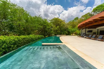 a swimming pool in the middle of a house at Villa Carao #3 - A Private 4 Bedroom Resort Villa in Brasilito