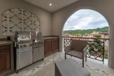 a kitchen with a stove and a balcony at Calle Cartagena 8C in Playa Danta