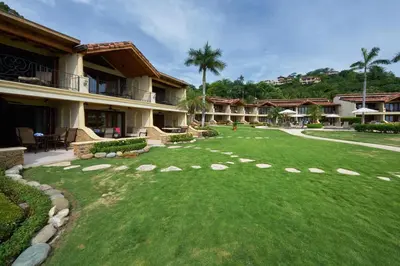 a large yard in front of a resort at Palms 3- Luxury Beachfront Villa in Playa Flamingo