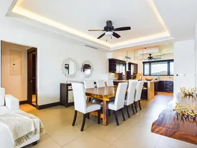 a dining room and kitchen with a table and chairs at 360 Splendor 309-Ocean View Residence-Breakfast Included! in Playa Flamingo