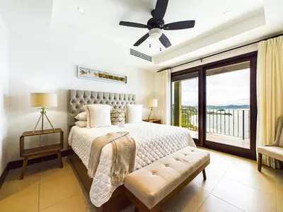 a bedroom with a bed and a window with a view at 360 Splendor 309-Ocean View Residence-Breakfast Included! in Playa Flamingo