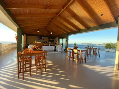 a restaurant with wooden tables and chairs on a balcony at 360 Splendor 309-Ocean View Residence-Breakfast Included! in Playa Flamingo