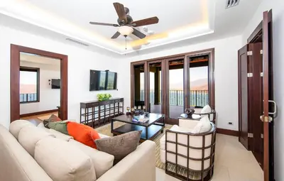a living room with a couch and a ceiling fan at 360 Splendor 105F-Ocean View Residence-Breakfast in Playa Flamingo