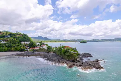 an island in a body of water with houses at 360 Splendor 105F-Ocean View Residence-Breakfast in Playa Flamingo