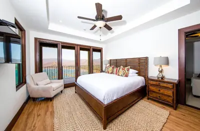 a bedroom with a bed and a ceiling fan at 360 Splendor 105F-Ocean View Residence-Breakfast in Playa Flamingo