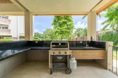 an outdoor kitchen with a stove and a sink at Peninsula 25 in Tamarindo