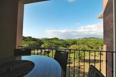 a balcony with a table and chairs and a view at Peninsula 25 in Tamarindo
