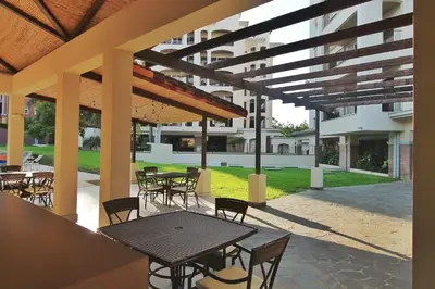 a patio with tables and chairs in a building at Peninsula 25 in Tamarindo