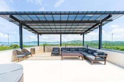 a living room with a couch and chairs on a roof at Peninsula 25 in Tamarindo