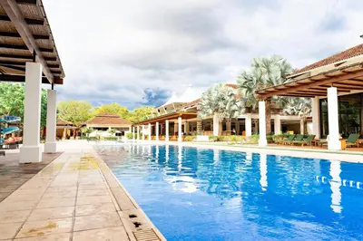 a swimming pool at a resort with blue water at Malinche 423-B, Ocean View 2 Br Condo At Reserva Conchal in Brasilito