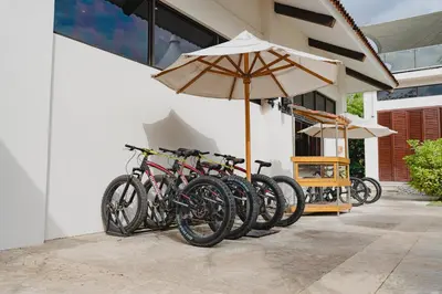 a row of bikes parked next to a building with an umbrella at Malinche 423-B, Ocean View 2 Br Condo At Reserva Conchal in Brasilito