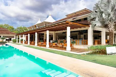 a resort with a swimming pool in front of a building at Malinche 423-B, Ocean View 2 Br Condo At Reserva Conchal in Brasilito