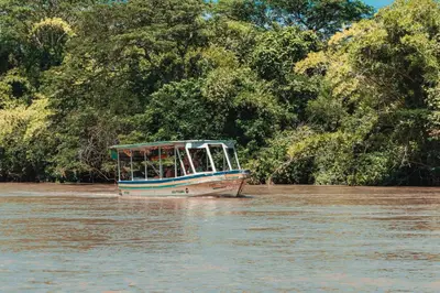 a boat in the water on a river at Malinche 423-B, Ocean View 2 Br Condo At Reserva Conchal in Brasilito