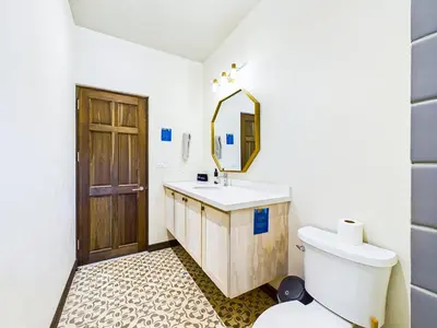 a bathroom with a toilet and a sink and a mirror at Miraflores 42 Ocean View Condo At Las Catalinas in Playa Danta