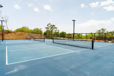a tennis court with two tennis nets on it at Casa De Los Sueños, Brand New Ocean View Home On 125 Acres! in Brasilito