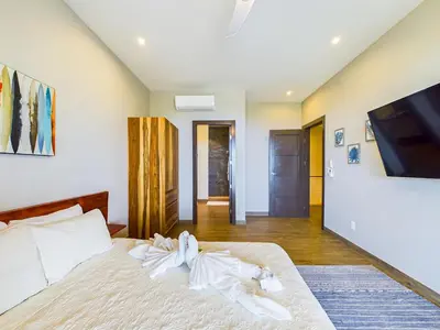 a bedroom with a bed with a tv on the wall at Dos Rios #70- 6 Bedroom Home On 12 Acre in Brasilito