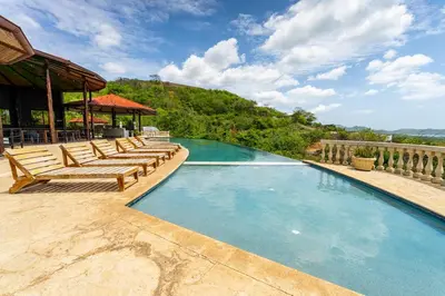 a swimming pool with lounge chairs and a gazebo at Dos Rios #70- 6 Bedroom Home On 12 Acre in Brasilito