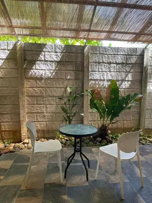 a patio with a table and two chairs at Cabinas El Colibri, Apart Hotel in Carrillo