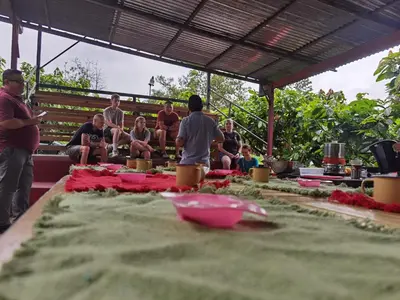 a group of people sitting around a table with a cake at The Chocolate Lodge in Jiménez