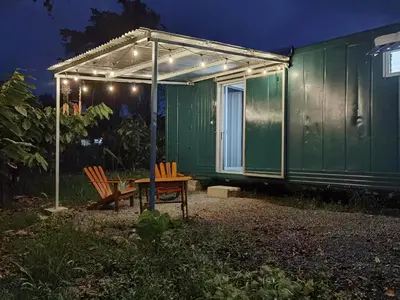 a green house with a picnic table and a tent at The Chocolate Lodge in Jiménez