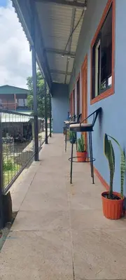 a building with a row of tables and potted plants at Siary Aparment 2 in Monteverde Costa Rica