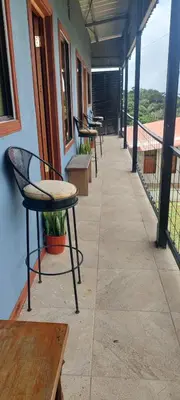 a row of chairs and tables on a balcony at Siary Aparment 2 in Monteverde Costa Rica