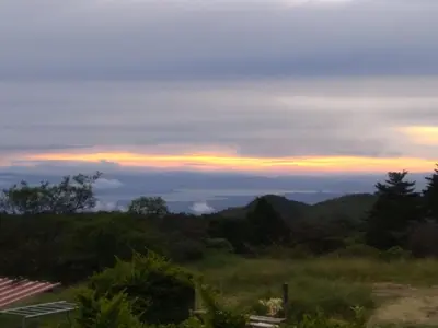 a view of a sunset from a hill with trees at Siary Aparment 2 in Monteverde Costa Rica