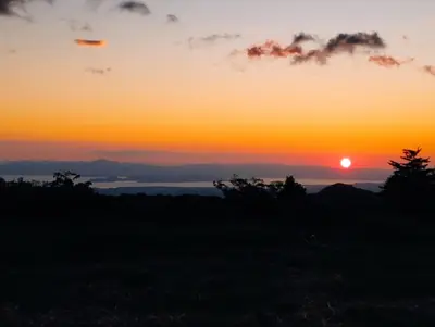 a sunset with the sun setting in the sky at Siary Aparment 2 in Monteverde Costa Rica