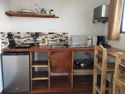 a kitchen with a wooden counter top and a sink at Siary Aparment 2 in Monteverde Costa Rica