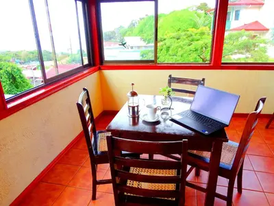 a laptop on a table in a room with windows at Miztli Lodge & Adventure in Monteverde Costa Rica