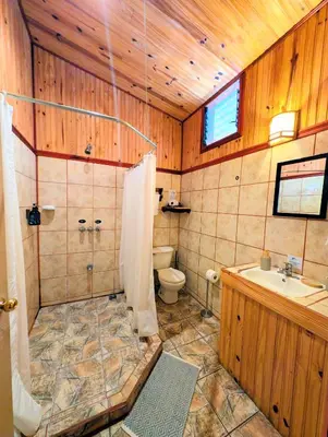 a bathroom with a shower and a toilet and a sink at Miztli Lodge & Adventure in Monteverde Costa Rica