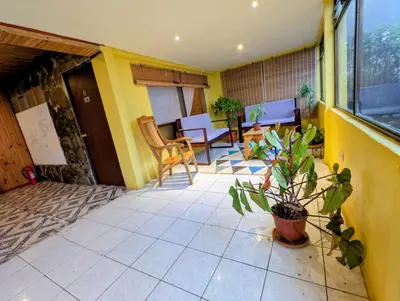 a room with a patio with a table and chairs at Miztli Lodge & Adventure in Monteverde Costa Rica