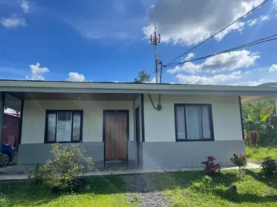 a small white house with a brown door at Large & Confortable Family House in Fortuna