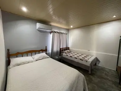 a bedroom with a bed and a couch in it at Large & Confortable Family House in Fortuna