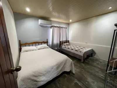 a bedroom with two beds and a window at Large & Confortable Family House in Fortuna