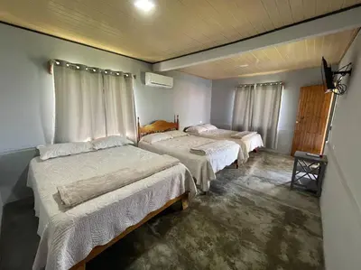 a bedroom with three beds in a room at Large & Confortable Family House in Fortuna