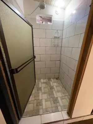 a bathroom with a shower with a glass door at Large & Confortable Family House in Fortuna