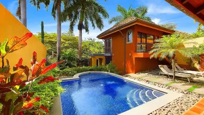 a house with a swimming pool in front of a house at Jade Coast #2 in Tamarindo