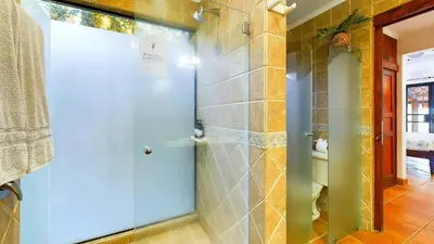 a shower with a blue door in a bathroom at Jade Coast #2 in Tamarindo