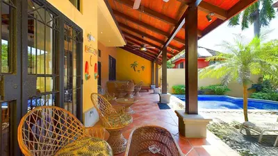 an outdoor patio with chairs and a swimming pool at Jade Coast #2 in Tamarindo